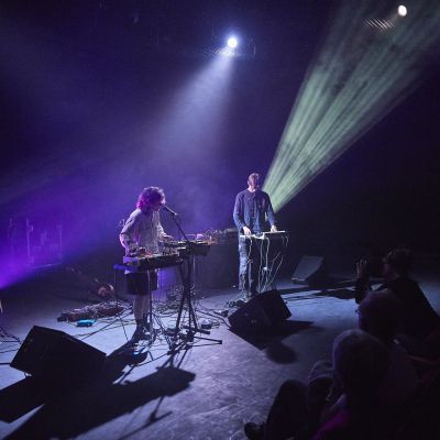 Electronic and Produced Music Students performing on stage with a purple hue lighting